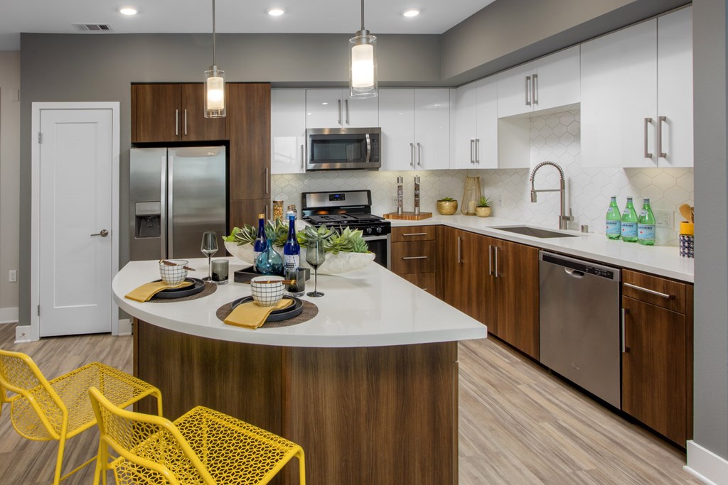 Apartments for Rent in Irvine - The Royce - Kitchen with Stainless-Steel Appliances, Glossy White Cabinetry, and Quartz Countertops